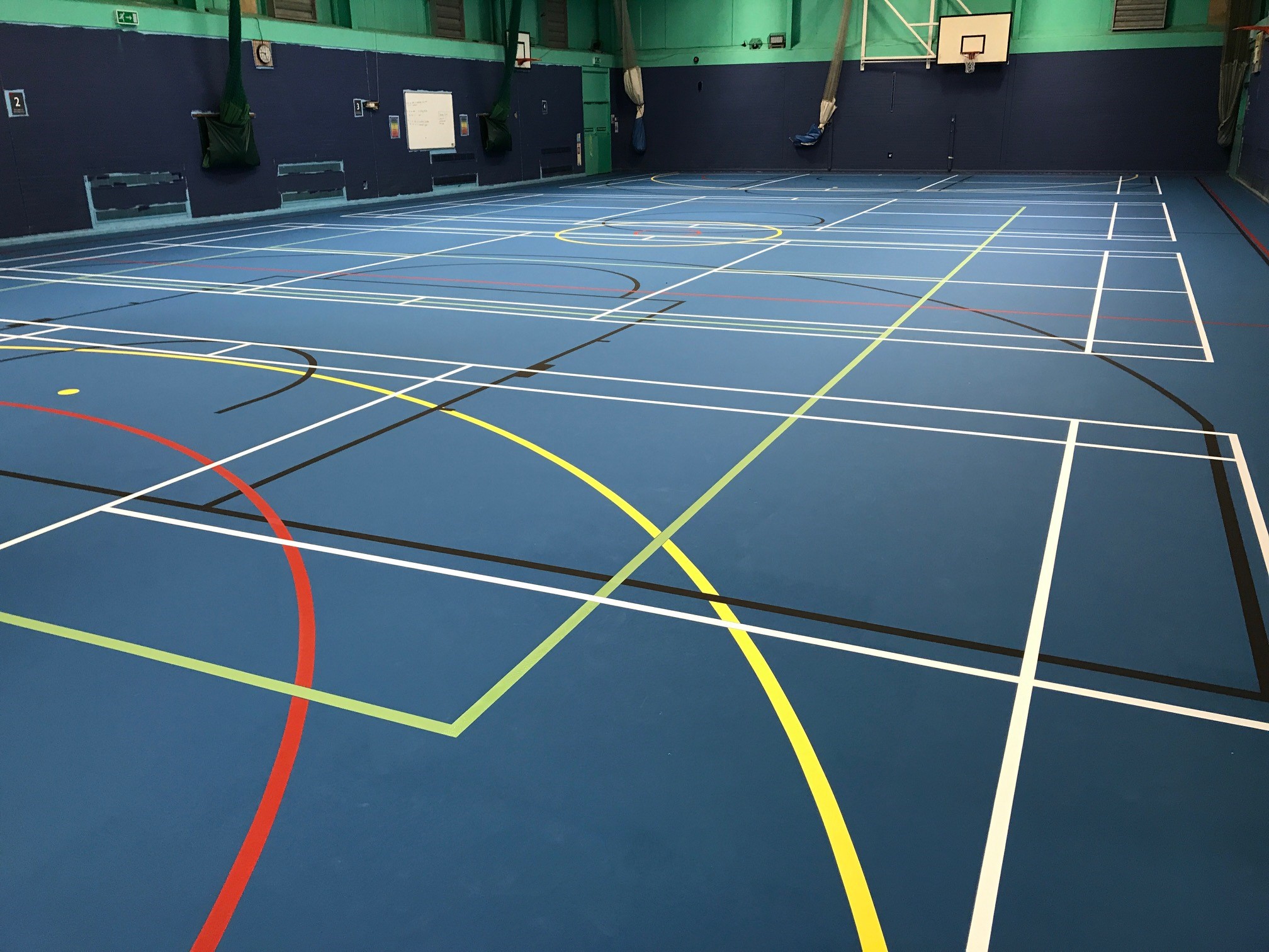 Blue Pulastic sports hall floor installed by Sports Surface UK with court markings