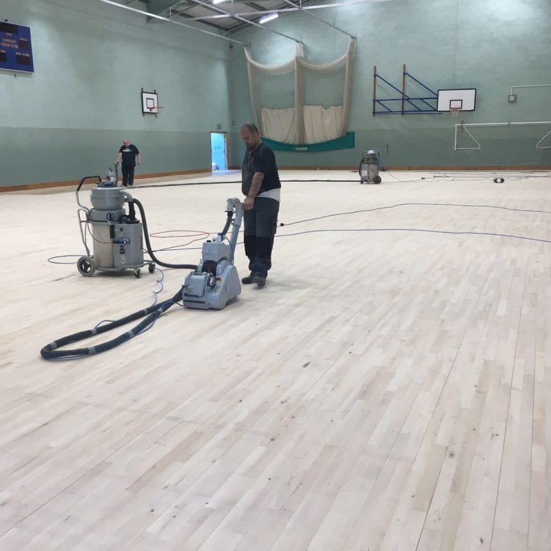 installation of Indoor timber sports hall floor with court markings for leisure centre