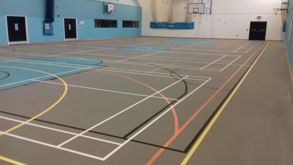 New school indoor sports hall installation of pulastic floor with court marking by Sports Surfaces UK