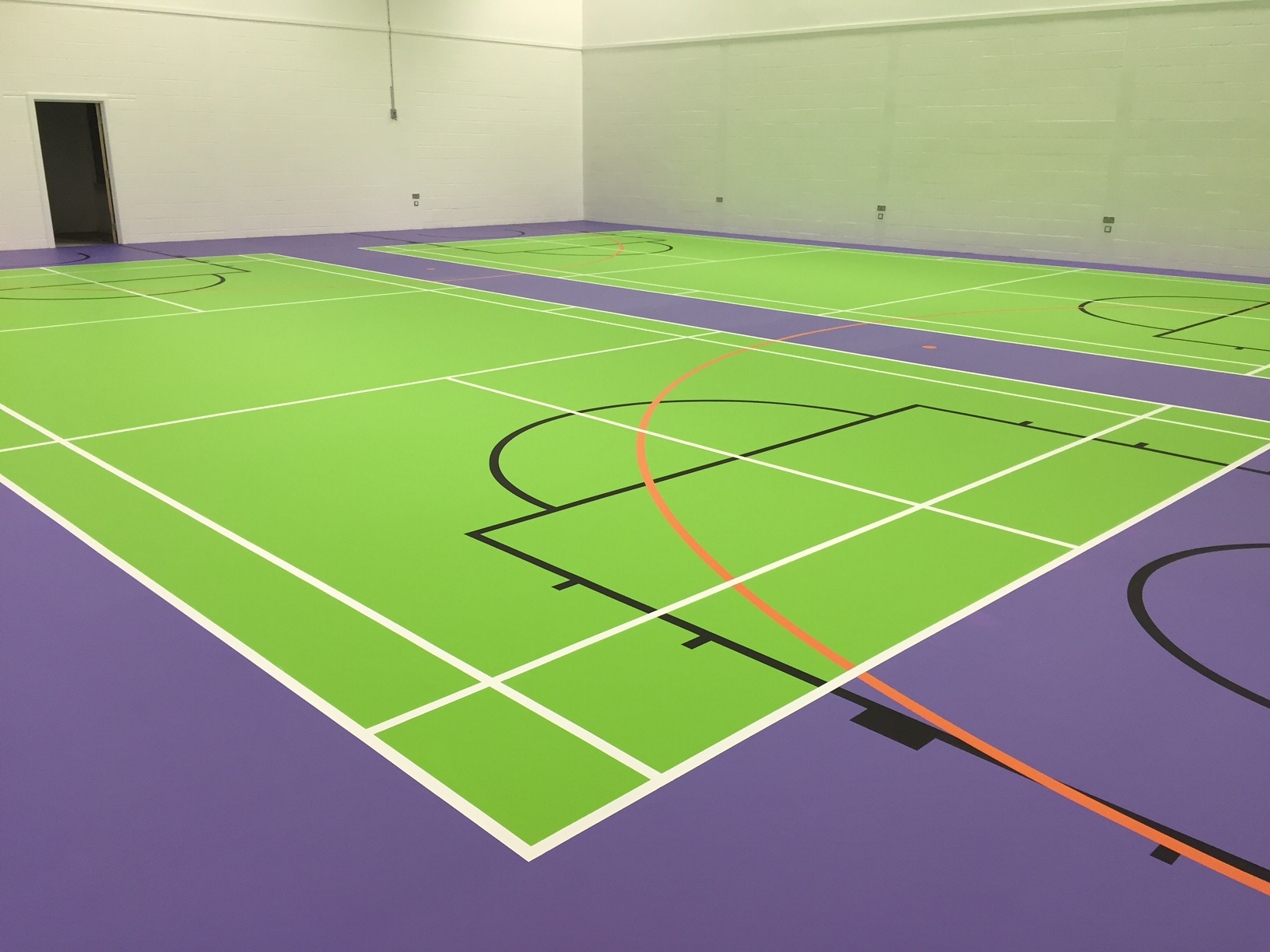 Green and purple pulastic sports hall floor with court markings by Sports Surfaces UK