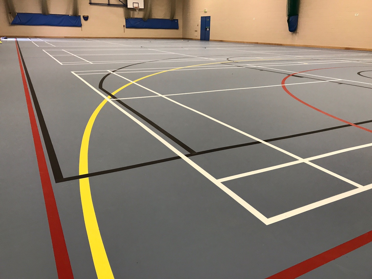 indoor school multi-use pulastic sports floor installation with court markings by Sports Surfaces UK