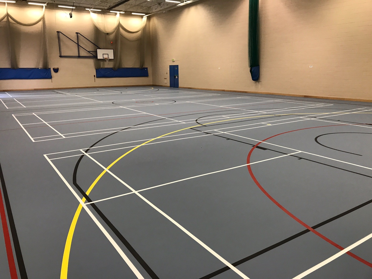 indoor school multi-use pulastic sports floor installation with court markings by Sports Surfaces UK
