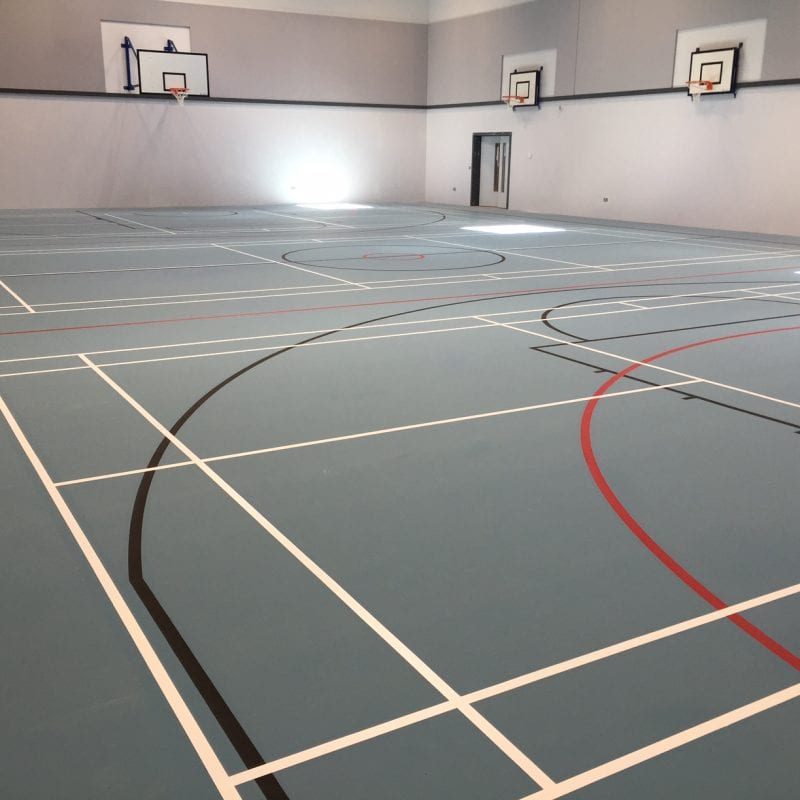 blue pulastic school sports hall floor with court markings by Sports Surfaces UK