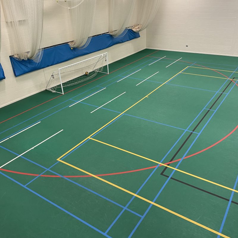 Freshly refurbished netball court with green Uni-Turf surface installed by expert sports flooring contractors