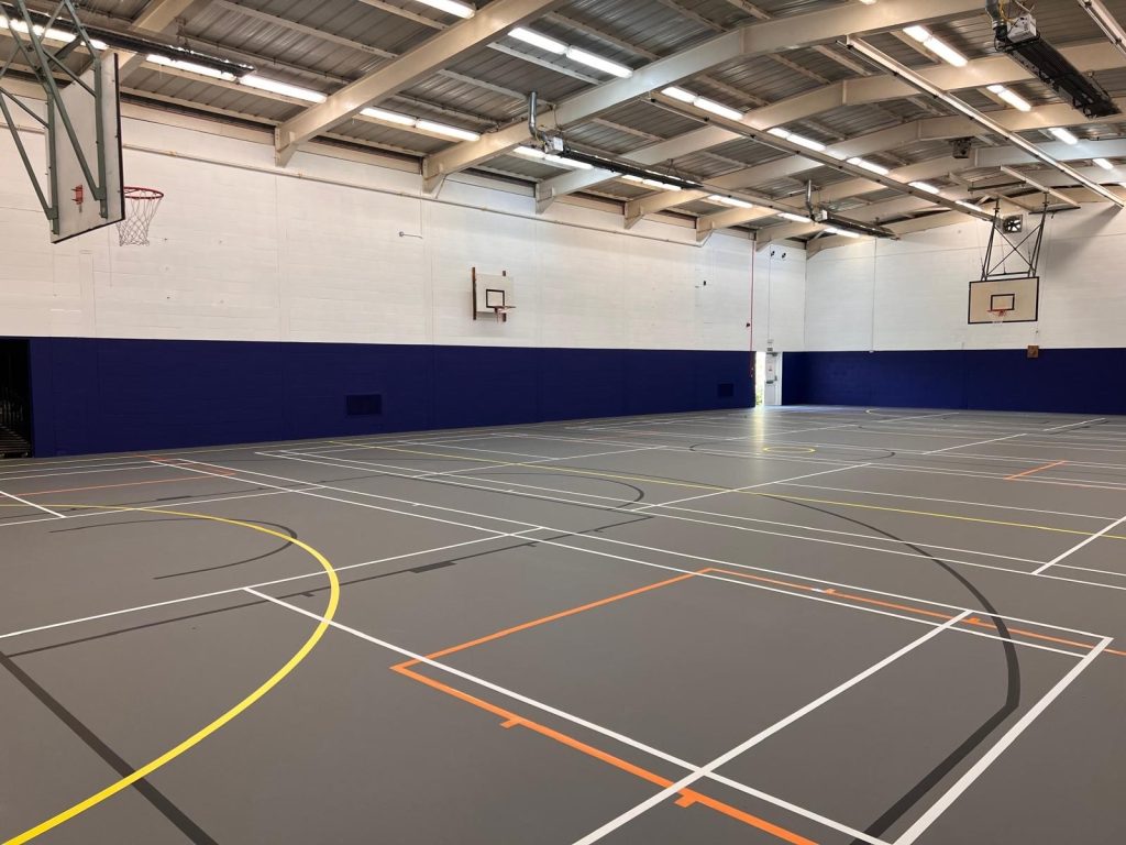 Pulastic Classic 110 indoor sports floor over two existing Granwood floors at a sports facility in Woking.